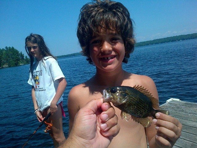 saab 269.jpg - Carter and a Rock Bass from the Cottage.